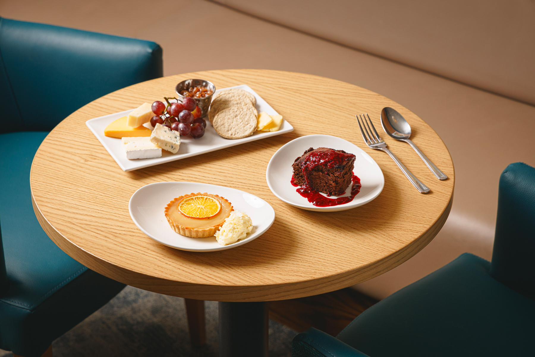 Round table with 3 desserts available on Caledonian Sleeper. 