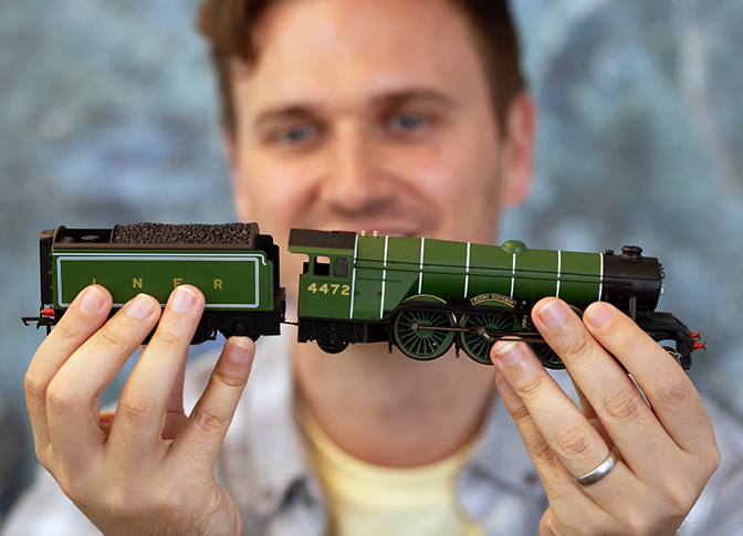 Man holding a Hornby model train.